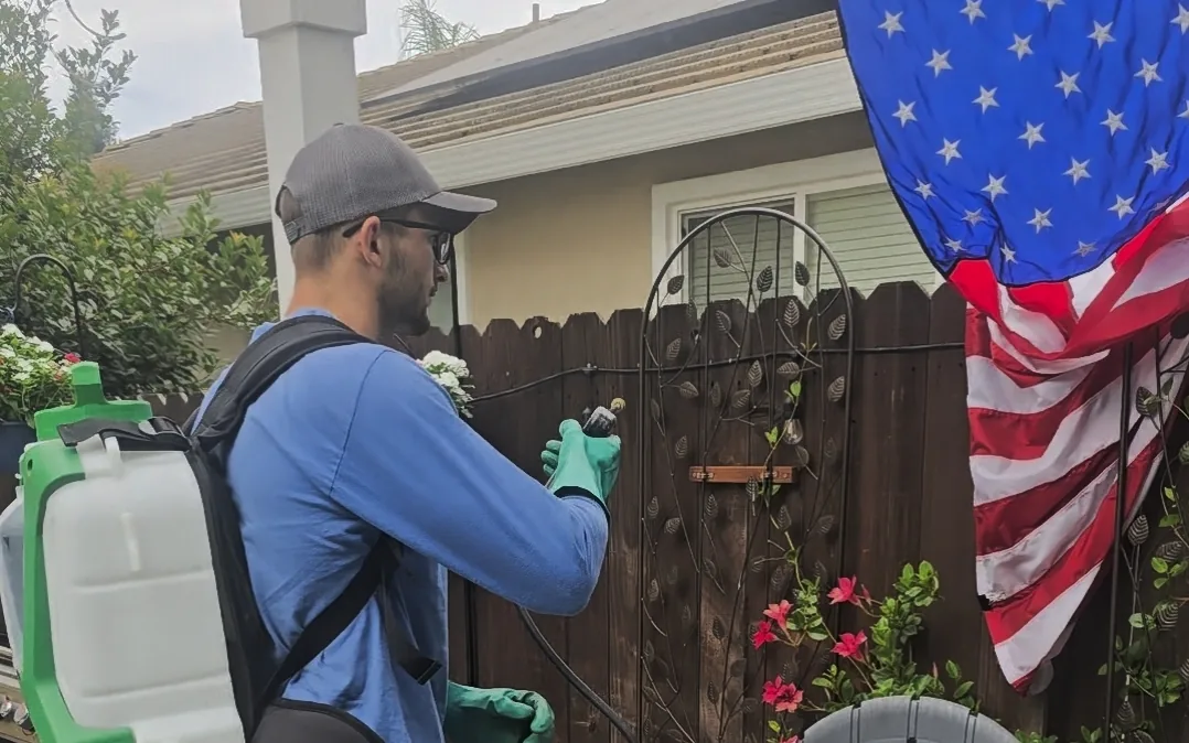 Summit Pest Control technician treating a covered patio during a general pest control visit