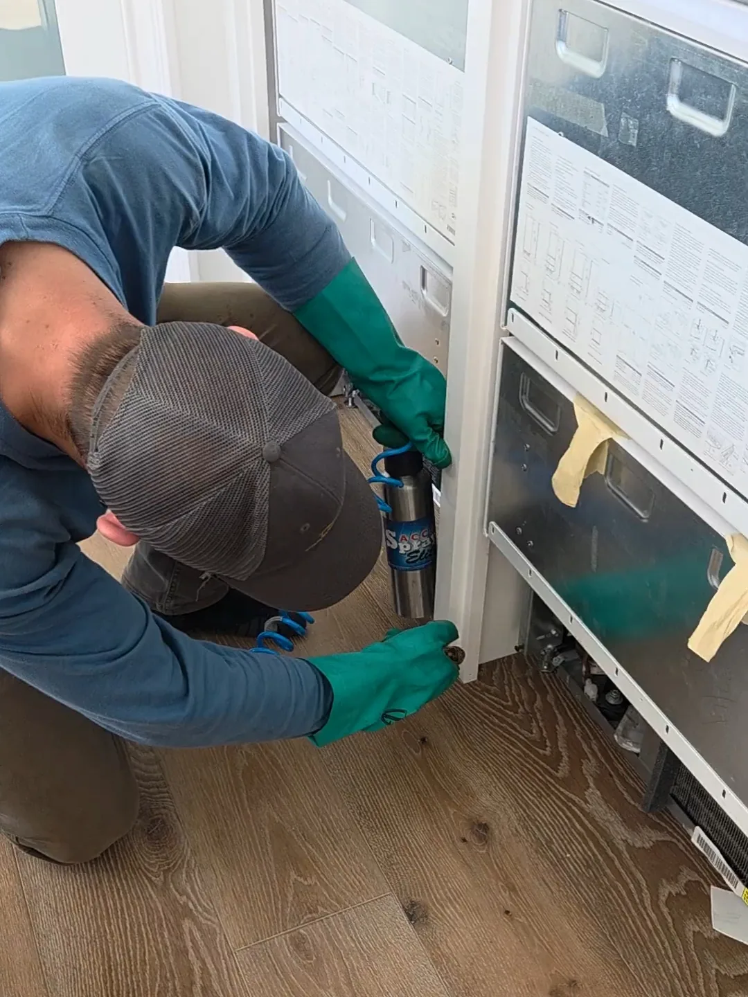 Technician inspecting a sliding-door track during a home visit
