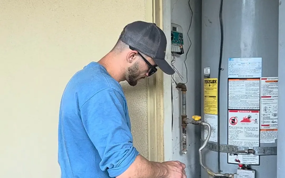 Technician servicing an exterior utility closet on a scheduled visit